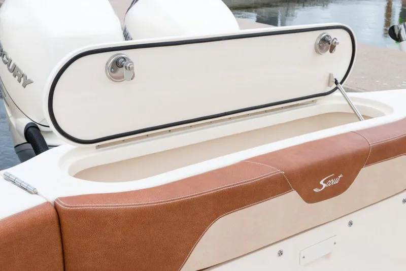 Slide: The Image of Manufacturer Provided Image: 2021 Scout 355 LXF boat with open storage compartment and brown seating. - 107