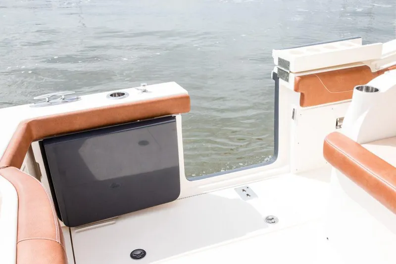 Slide: The Image of Manufacturer Provided Image: 2021 Scout 355 LXF boat interior with open side door and water view. - 108