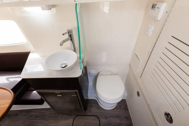 Slide: The Image of Manufacturer Provided Image: 2021 Scout 355 LXF boat bathroom with sink, toilet, and modern fixtures. - 112