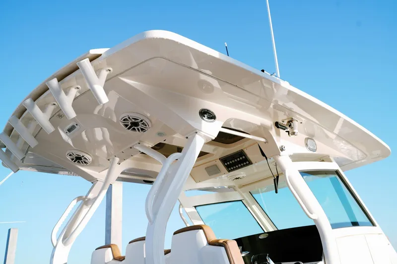 Slide: The Image of 2021 Scout 355 LXF boat with sleek design and advanced features under clear blue sky. - 15