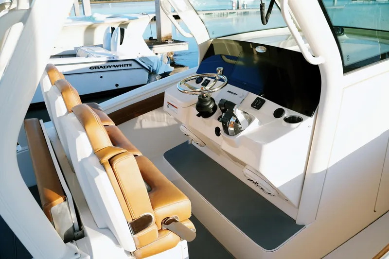 Slide: The Image of 2021 Scout 355 LXF boat cockpit with leather seats and modern controls. - 18