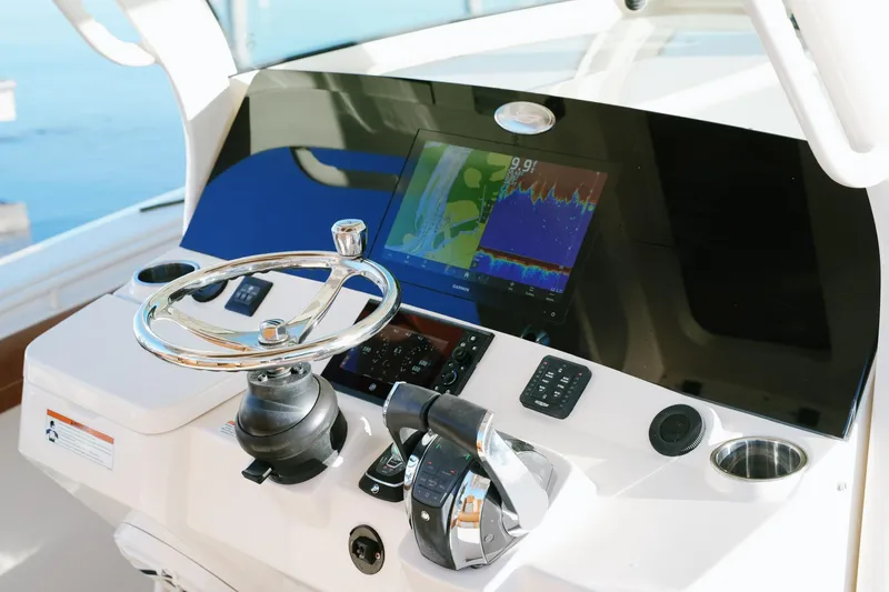 Slide: The Image of 2021 Scout 355 LXF helm with steering wheel and navigation display. - 19