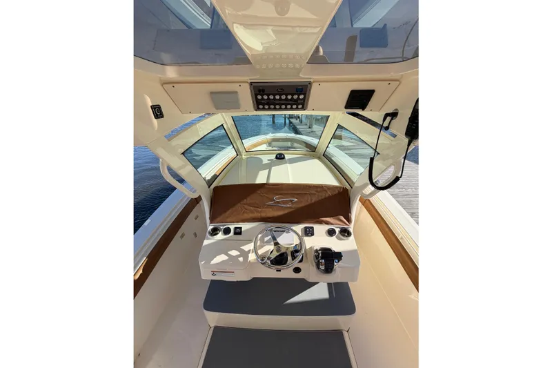 Slide: The Image of 2021 Scout 355 LXF boat helm with steering wheel and controls. - 25