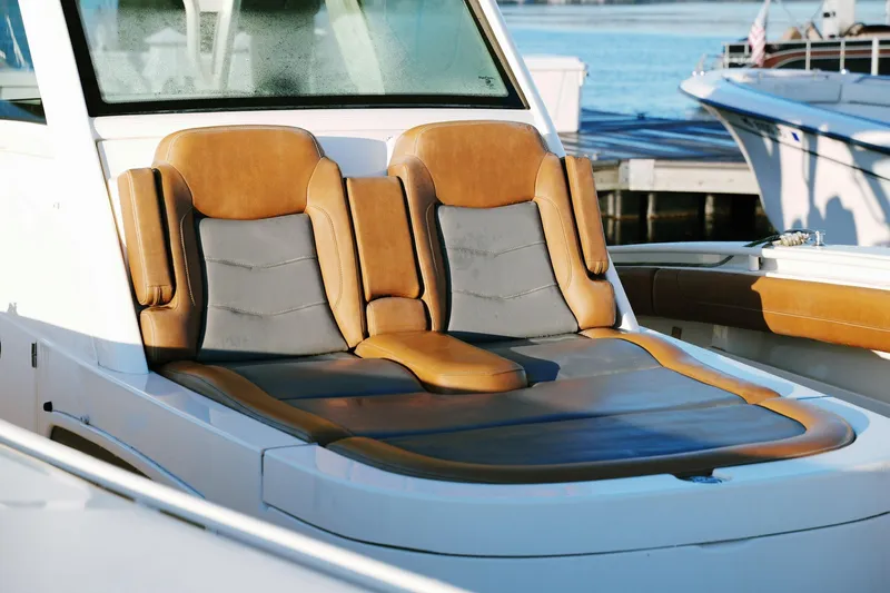Slide: The Image of 2021 Scout 355 LXF boat with luxurious tan and gray seating. - 34