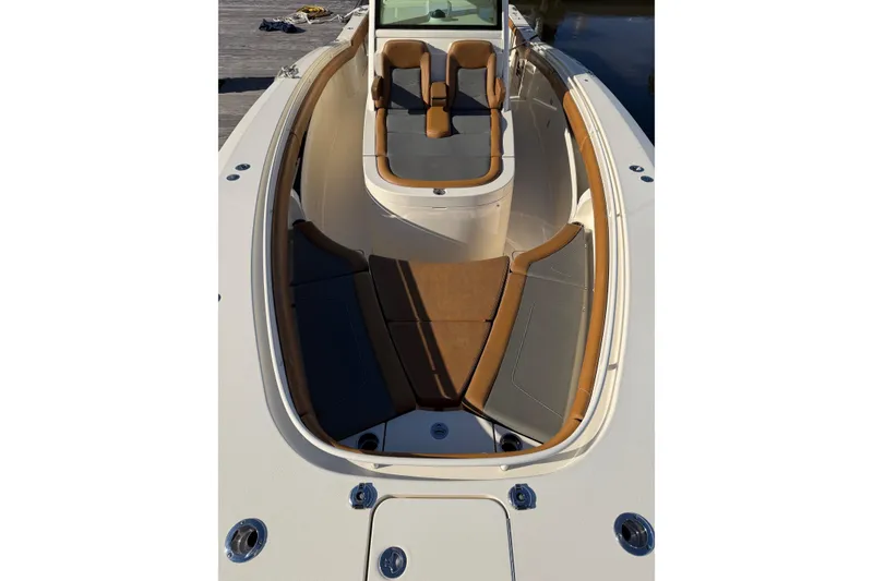 Slide: The Image of 2021 Scout 355 LXF boat interior with tan seating and sleek design. - 39