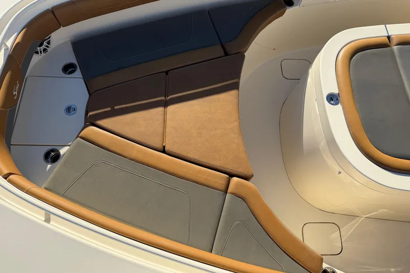 Slide: The Image of 2021 Scout 355 LXF boat interior with tan and gray seating. - 40