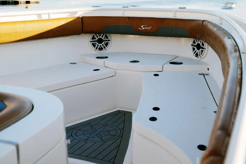 Slide: The Image of 2021 Scout 355 LXF boat interior with cushioned seating and speakers. - 42