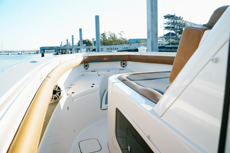 Slide: The Image of 2021 Scout 355 LXF boat interior with luxurious seating and modern design at a marina. - 44