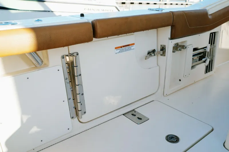 Slide: The Image of 2021 Scout 355 LXF boat interior with tan seating and storage compartments. - 47