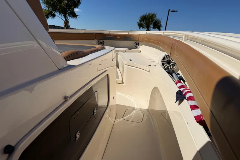 Slide: The Image of 2021 Scout 355 LXF boat interior with tan seating and storage compartments. - 52