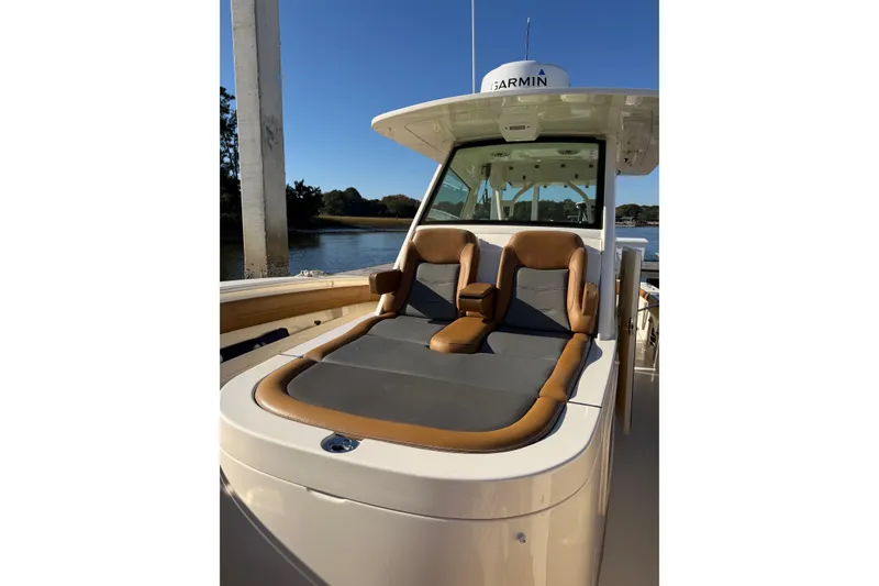 Slide: The Image of 2021 Scout 355 LXF boat with luxurious seating and Garmin equipment. - 54
