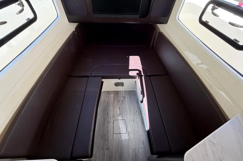 Slide: The Image of 2021 Scout 355 LXF cabin interior with seating and wood flooring. - 59