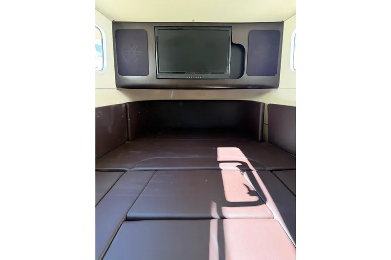 Slide: The Image of 2021 Scout 355 LXF cabin interior with TV and cushioned seating. - 60