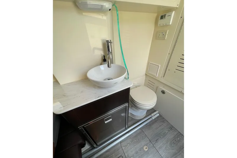 Slide: The Image of 2021 Scout 355 LXF boat bathroom with modern sink and toilet. - 61