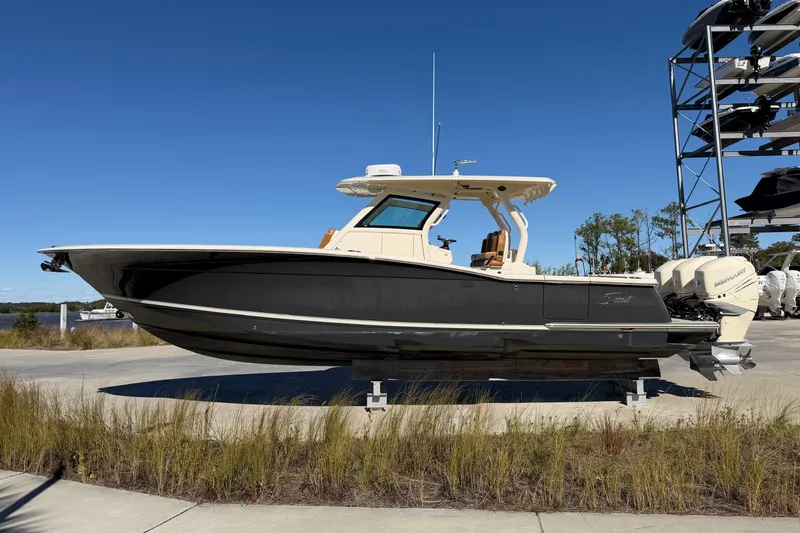 Slide: The Image of 2021 Scout 355 LXF boat on display, featuring sleek design and powerful engines. - 7