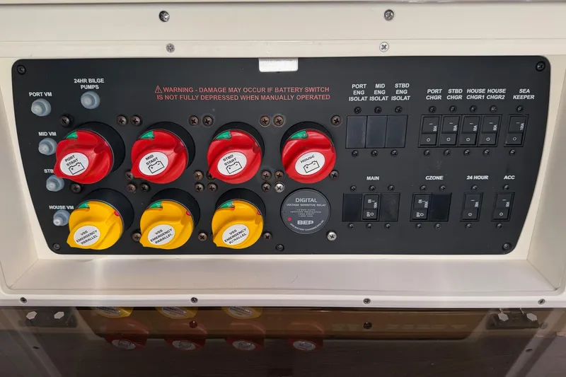 Slide: The Image of Control panel of a 2021 Scout 355 LXF boat with switches and warning labels. - 72