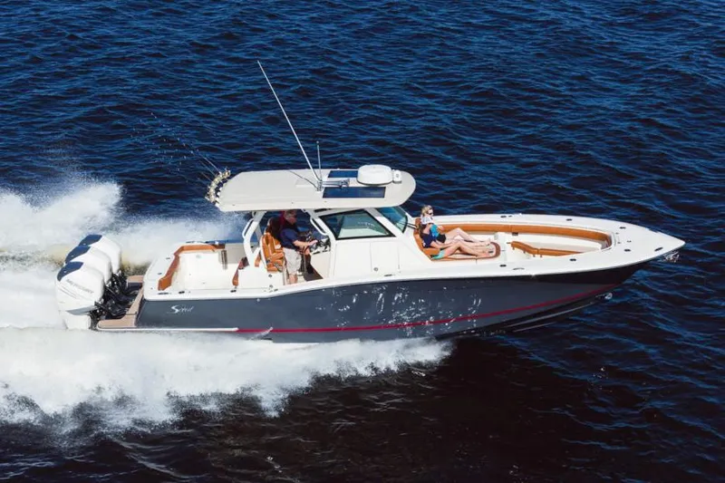 Slide: The Image of Manufacturer Provided Image: 2021 Scout 355 LXF boat cruising on open water. - 86