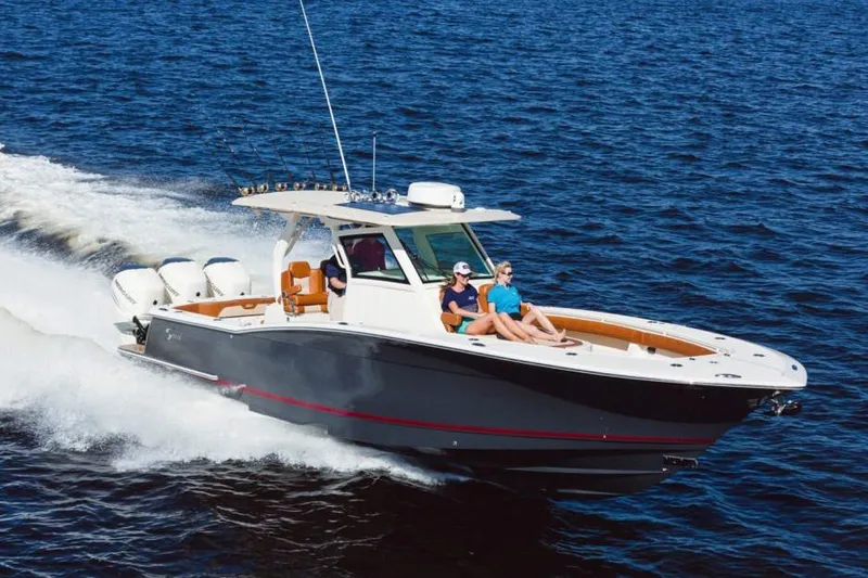 Slide: The Image of Manufacturer Provided Image: 2021 Scout 355 LXF boat cruising on open water. - 87