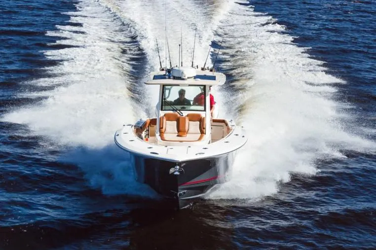Slide: The Image of Manufacturer Provided Image: 2021 Scout 355 LXF boat cruising on open water. - 88