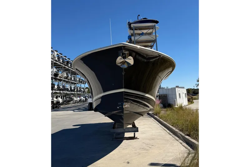 Slide: The Image of 2021 Scout 355 LXF boat on dry dock under clear blue sky. - 9