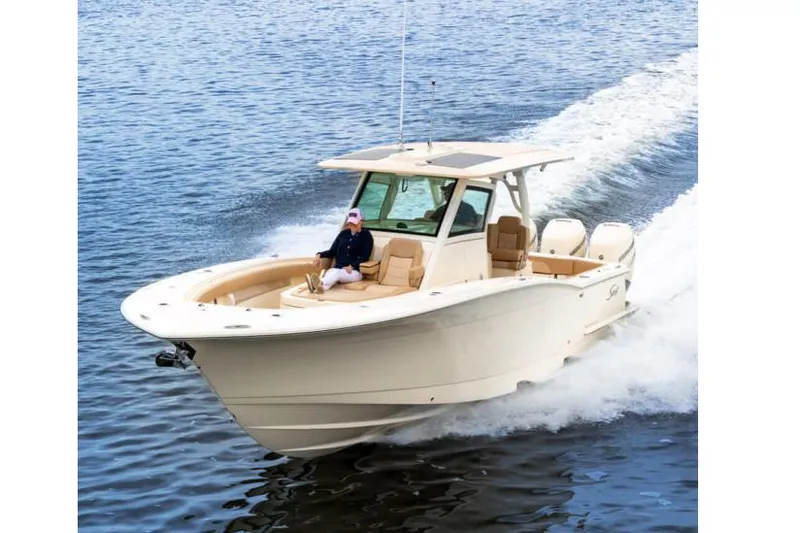 Slide: The Image of Manufacturer Provided Image: 2021 Scout 355 LXF boat cruising on water. - 90