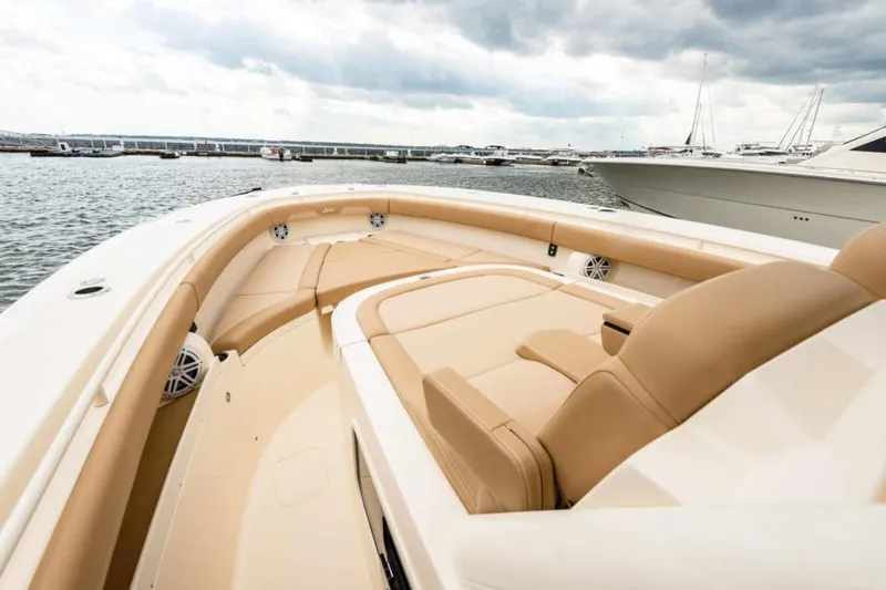 Slide: The Image of Manufacturer Provided Image: 2021 Scout 355 LXF boat with luxurious tan seating at the marina. - 92