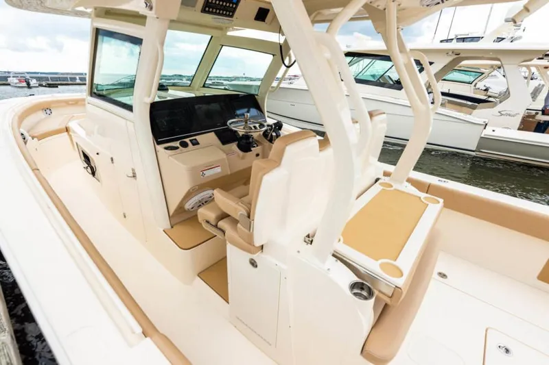 Slide: The Image of Manufacturer Provided Image: 2021 Scout 355 LXF boat interior with helm and seating area. - 97