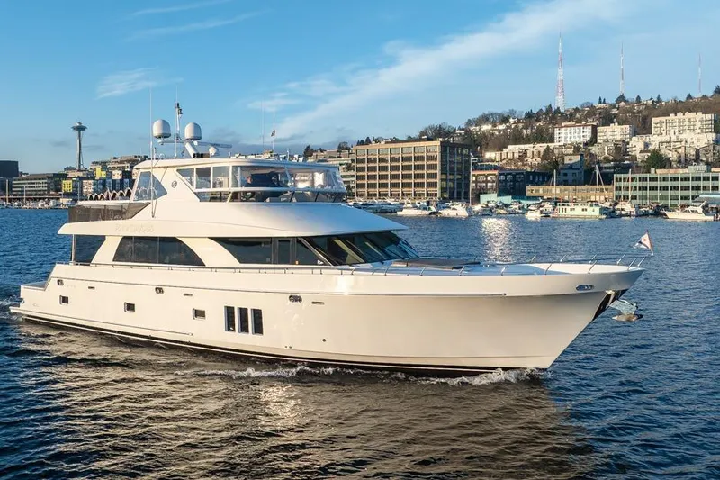 The Image of 2014 Ocean Alexander 85 Cockpit Motoryacht cruising in a scenic waterfront setting. - 0