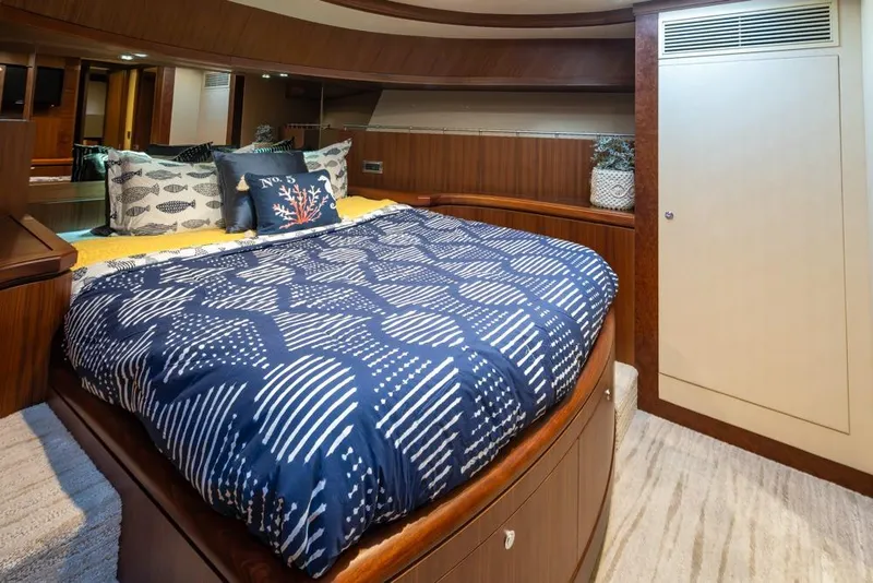 Slide: The Image of Luxurious bedroom in 2014 Ocean Alexander 85 Cockpit Motoryacht with elegant bedding and wood accents. - 12