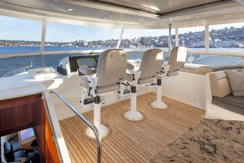 Slide: The Image of Luxurious 2014 Ocean Alexander 85 Cockpit Motoryacht helm with panoramic water views. - 16