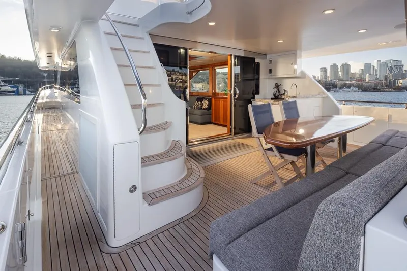 Slide: The Image of Luxurious 2014 Ocean Alexander 85 Cockpit Motoryacht with elegant outdoor seating and city skyline view. - 19