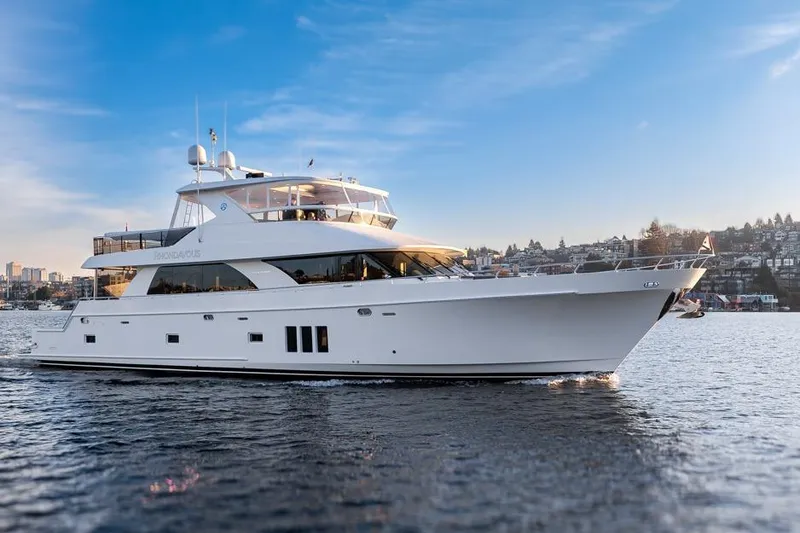 Slide: The Image of 2014 Ocean Alexander 85 Cockpit Motoryacht cruising on a serene waterway. - 20