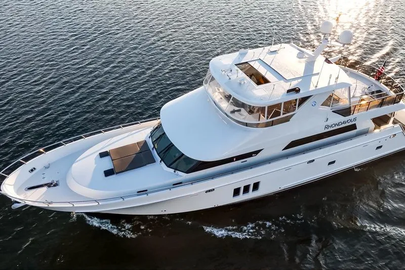 Slide: The Image of 2014 Ocean Alexander 85 Cockpit Motoryacht cruising on open water at sunset. - 22