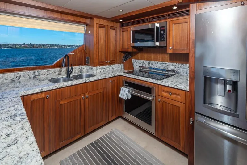 Slide: The Image of Luxurious kitchen in 2014 Ocean Alexander 85 Cockpit Motoryacht with wood cabinetry and ocean view. - 25