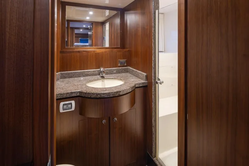 Slide: The Image of Luxurious bathroom in 2014 Ocean Alexander 85 Cockpit Motoryacht with wood cabinetry and granite countertop. - 33