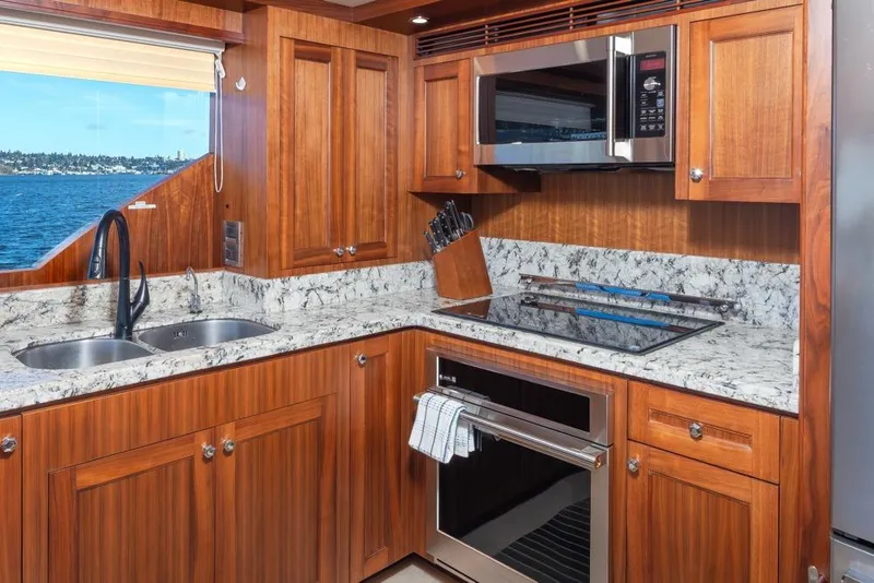 Slide: The Image of Luxurious kitchen in 2014 Ocean Alexander 85 Cockpit Motoryacht with wood cabinetry and ocean view. - 35