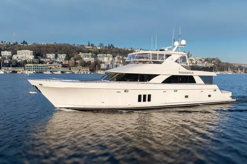 Slide: The Image of 2014 Ocean Alexander 85 Cockpit Motoryacht cruising on a scenic waterfront. - 4