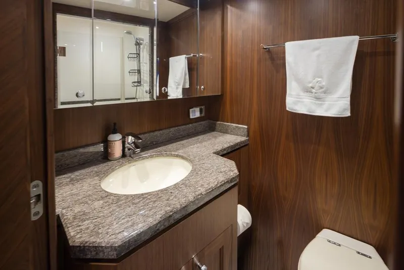 Slide: The Image of Luxurious bathroom in 2014 Ocean Alexander 85 Cockpit Motoryacht with wood paneling and granite countertop. - 54