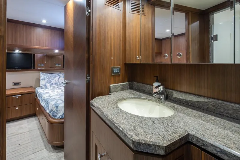 Slide: The Image of Luxurious bathroom and bedroom in 2014 Ocean Alexander 85 Cockpit Motoryacht, featuring wood finishes. - 55
