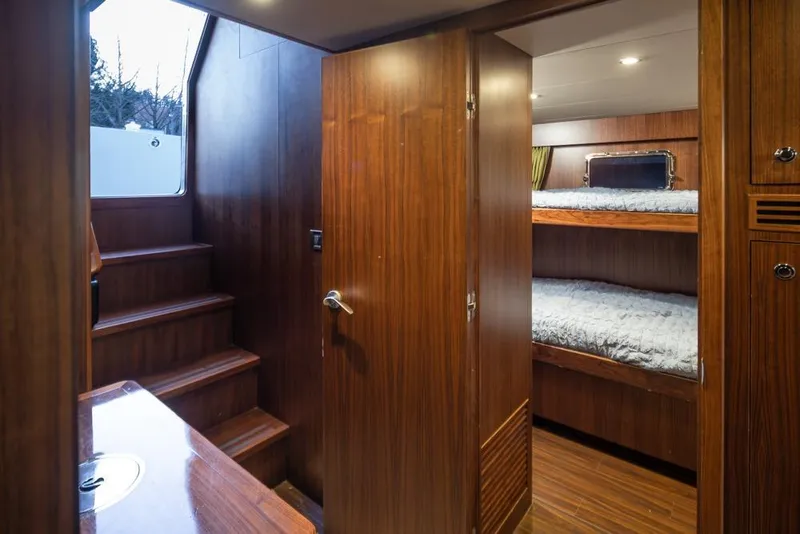 Slide: The Image of Interior of 2014 Ocean Alexander 85 Cockpit Motoryacht with wooden stairs and bunk beds. - 56