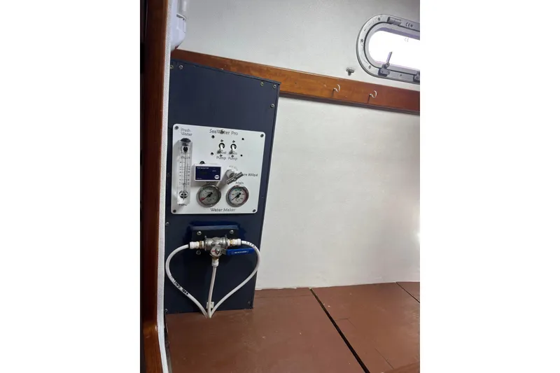 Slide: The Image of Water maker system inside 2000 Fountaine Pajot Belize 43 catamaran, featuring control panel and gauges. - 20