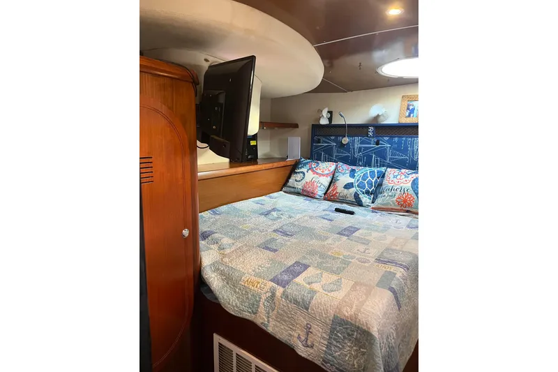 Slide: The Image of Cozy bedroom interior of 2000 Fountaine Pajot Belize 43 catamaran with nautical-themed decor. - 35