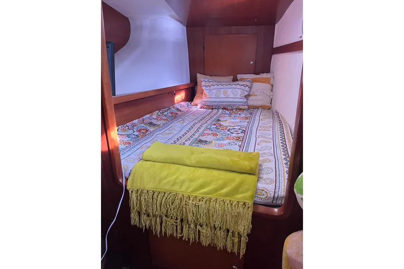 Slide: The Image of Cozy cabin interior of 2000 Fountaine Pajot Belize 43 with colorful bedding and pillows. - 13
