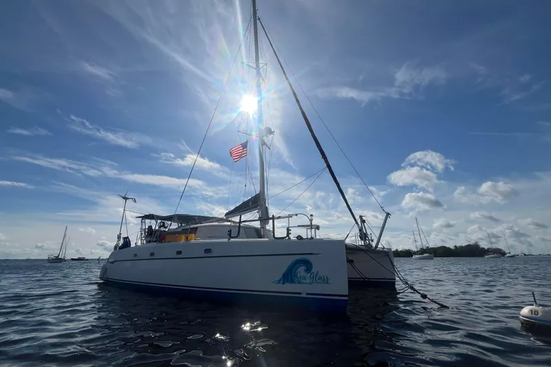 Slide: The Image of 2000 Fountaine Pajot Belize 43 catamaran sailing on a sunny day with American flag. - 21