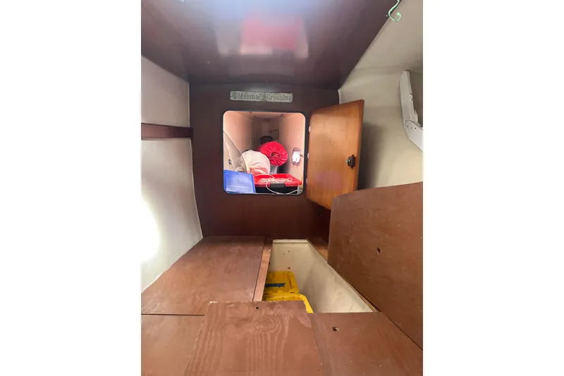 Slide: The Image of Interior cabin of 2000 Fountaine Pajot Belize 43 catamaran, featuring wooden storage and open hatch. - 25