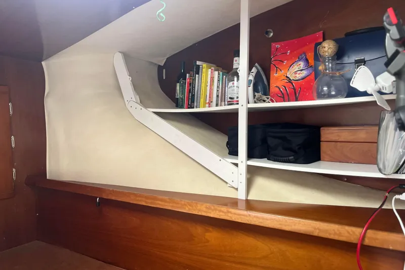 Slide: The Image of Interior of 2000 Fountaine Pajot Belize 43 with shelves, books, and decorative items. - 27