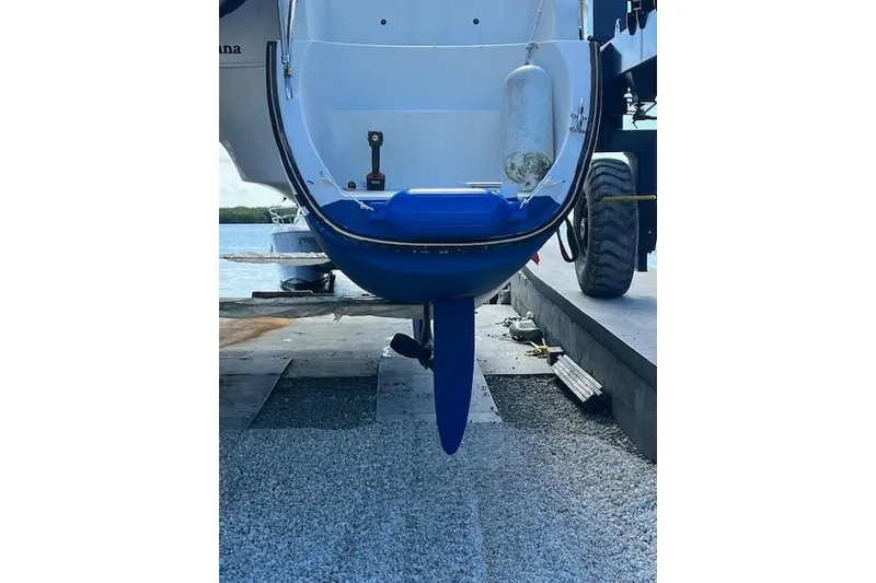 Slide: The Image of Fountaine Pajot Belize 43 catamaran, 2001 model, on dry dock with visible rudder and propeller. - 38