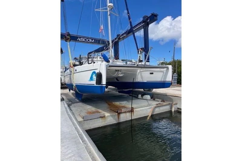 Slide: The Image of 2001 Fountaine Pajot Belize 43 catamaran on a lift, blue sky background. - 39