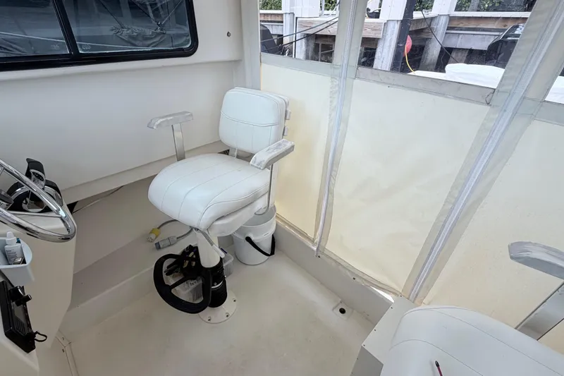 Slide: The Image of 2001 Parker 2520 Deep Vee Sport Cabin boat on calm ocean waters under blue sky. - 8