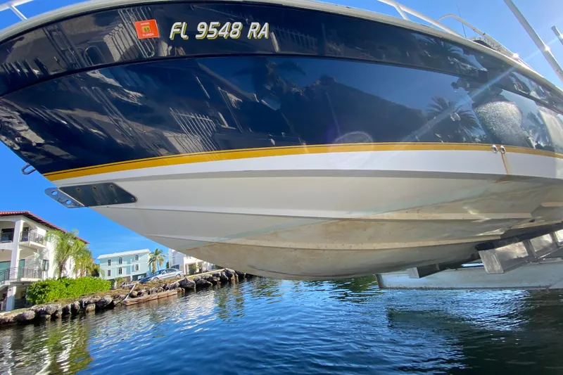 Slide: The Image of 2004 Deep Impact 36 DI boat on lift, reflecting water and buildings. - 11